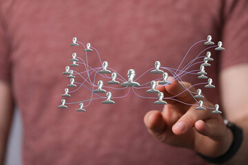 Hand interacts with a digital network, representing teamwork and connections. Illustrating...