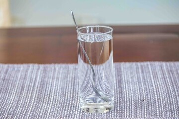 Minimalist crystal glass with clean, cold water.