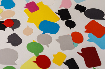 Abstract image featuring colorful speech bubbles scattered on a white surface. Concept for communication, dialogue, and social media. Vivid colo