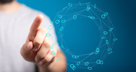 A person's finger pointing toward a glowing digital network sphere, representing technology,...