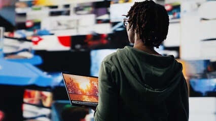 Person entertained by clips on laptop, enjoying technology bridging people worldwide. Woman using...