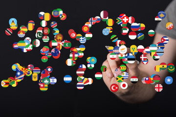 Diverse global flags concept symbolizing the world and globalization. Digital hand interacting with flags of different countries in a connection