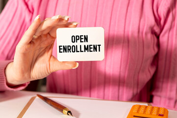 Stethoscope and notepad with text open enrollment Medical concept.