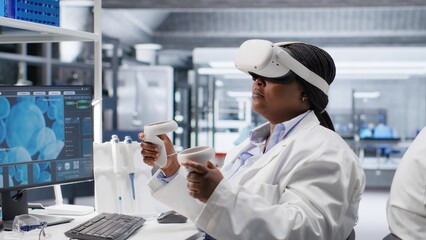 Woman expert in laboratory using VR headset to simulate experiment and research study. Virtual reality tech supporting microbiology and advanced medical discovery in healthcare.
