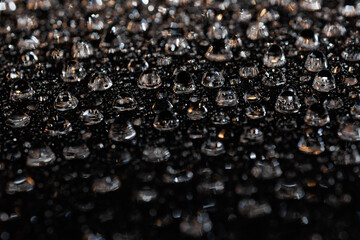 macro close-up of water droplets on a dark background. Mockup for your logo. horizontal wallpaper or web banner.