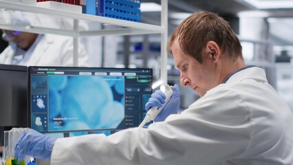 Professional chemistry scientist works in biolab with pipette and jar, preparing chemical mixture. Laboratory procedure emphasizes molecular biology and bioengineering in research.