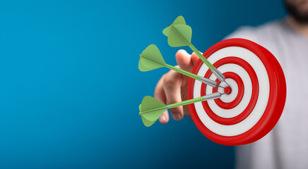 An image of darts hitting the bulls eye, symbolizing a achieved target and showing the focus needed...