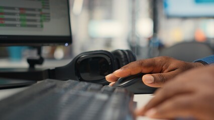 Close up of black employee leverages report writing for business development and monthly...