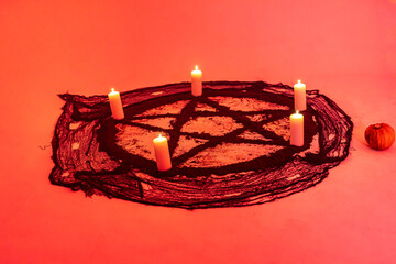 Images of red and black pentagrams representing mystical and esoteric symbols linked to...