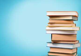 stack of school reading books on color background,