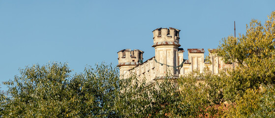 Close-up of the Imperial Palace Stables in Peterhof, Russia, showing weathered stone towers above...