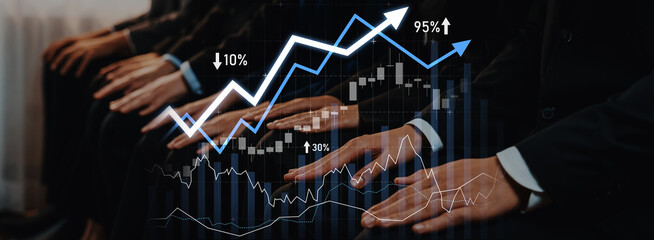 A professional audience attentively analyzes financial graphs and stock market trends in a business...