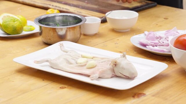 Peruvian chef preparing traditional guinea pig dish