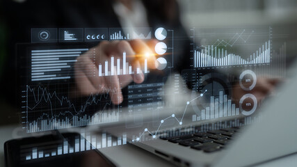 A business professional uses advanced digital tools to interact with data visualizations, enhancing analysis of performance metrics and trends in a corporate setting. Scalp