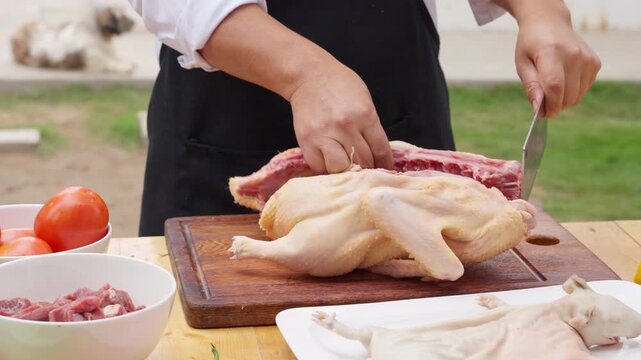 Peruvian chef preparing duck and guinea pig outdoors