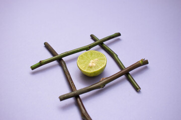 Lime and Bamboo Cross on Lavender Surface
