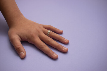 Young Hand on Lavender Background