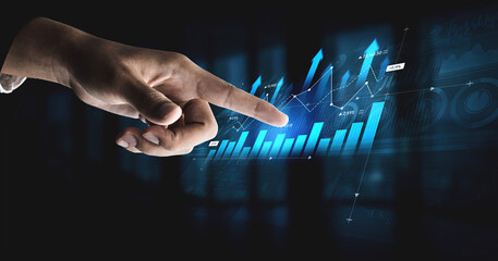 A hand reaching towards a vibrant digital display of graphs and charts, symbolizing engagement with...