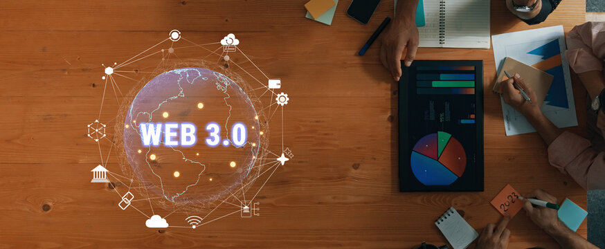 Business professionals engaged in Web 3.0 technology discussions, showcasing charts and graphs on a modern desk. Ideal for digital innovation and collaboration themes. Trope