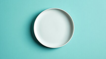 Minimalist plain white plate on a vibrant turquoise background for modern kitchen designs, culinary presentations, and stylish dining concepts
