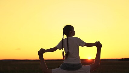 Happy family. Kid daughter sits on shoulders of his father. Carefree dad with daughter play, sun park. Fathers Day. Leisure for child. Kid girl having fun. Family holiday, parent. Superhero dad baby