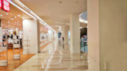 Fototapeta premium Blurry and Out of Focus Abstract Photo of a mall interior with large pillars and aesthetic light design. Perfect for background.