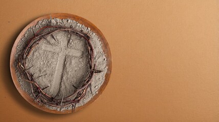 Gray ash cross on in plate. Ash Wednesday
