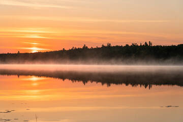 Golden Sunrise Over Misty Lake — Serene Wilderness Landscape Reflection