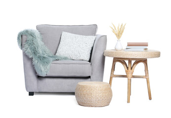 Comfortable armchair, side table, decor and pouf on white background