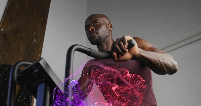 Using elliptical console handles, athlete wearing red tank top training in gym, with data overlays - Powered by Adobe
