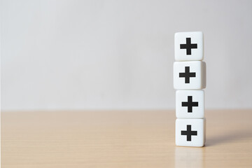 Plus sign in dice stacking. Addition and positive mindset thinking such as profit, benefits,...