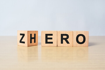 Cubes and dice with words from zero to hero on wooden background
