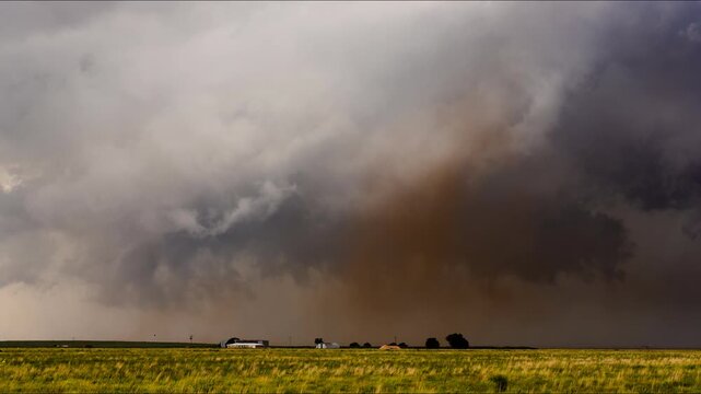 Tornado forming under rotating supercell cloud during severe weather 