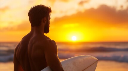 Fototapeta premium Surfer man watching ocean sunset holding surfboard