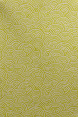 Light beige brocade fabric texture with wave pattern and yellow metallic lurex, textile collection