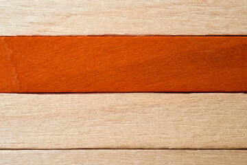 Wood texture featuring a distinct orange strip on light wood background