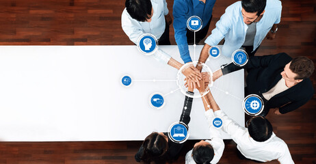 A diverse group of professionals collaborates at a workspace, symbolizing teamwork and innovation, surrounded by technology icons representing modern solutions and ideas. Amity