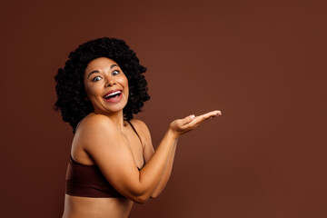 Charming young woman presenting with joy, embracing positivity and confidence in natural beauty