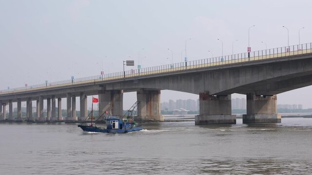 Fshing boats heading out to sea from the coastal port in Binhai, Tianjin, China.