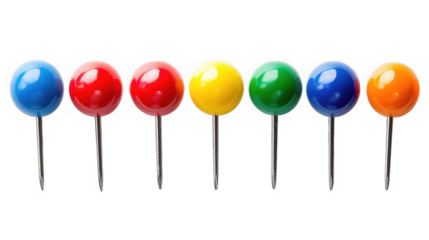 A row of seven push pins with colorful heads against a black background in a studio shot