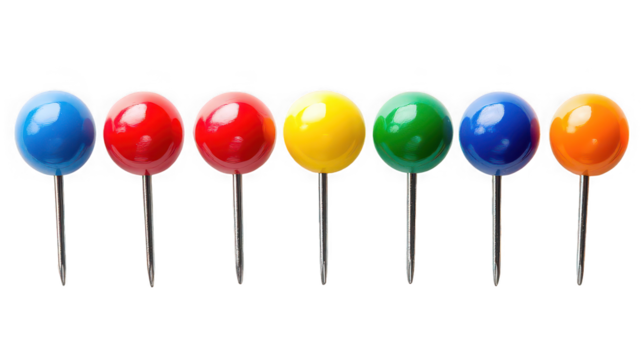 A row of seven push pins with colorful heads against a black background in a studio shot