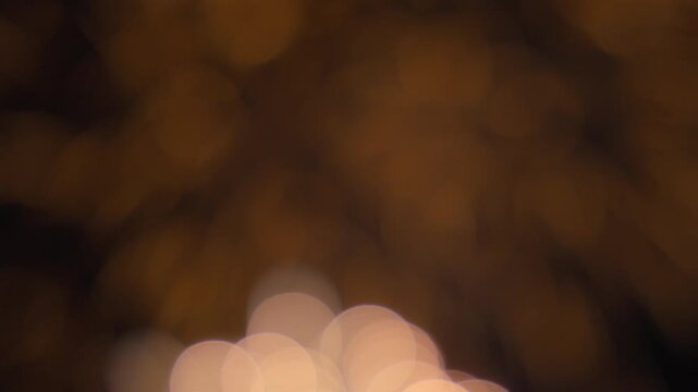 Bokeh lights of fireworks exploding on the night sky background