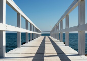 Obraz premium Brilliant white painted wooden planks and railings of a sunny coastal pier structure reflecting bright light near the water's edge ,background ,water ,structure