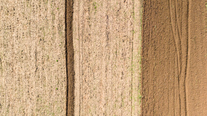 A beautiful abstract background of agricultural fields seen from a top down aerial perspective showing different colors and textures