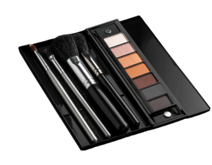Open makeup kit with brushes and eyeshadow palettes against a dark background, angled for a clear view