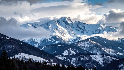 Snow Covered Mountain Peaks Under Dramatic Clouds During Golden Hour With Pine Forest In The Foreground