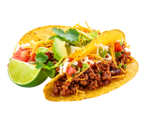 Two crispy tacos, one with lime, full of beef, lettuce, cheese, avocado, and tomato, on a black background