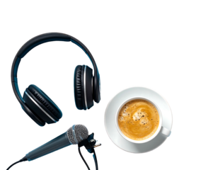 Overhead shot of black headphones, microphone and coffee cup with saucer, isolated against dark background