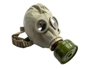 Old, tan, gas mask with olive canister and head straps, isolated against a black background