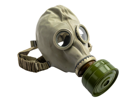 Old, tan, gas mask with olive canister and head straps, isolated against a black background